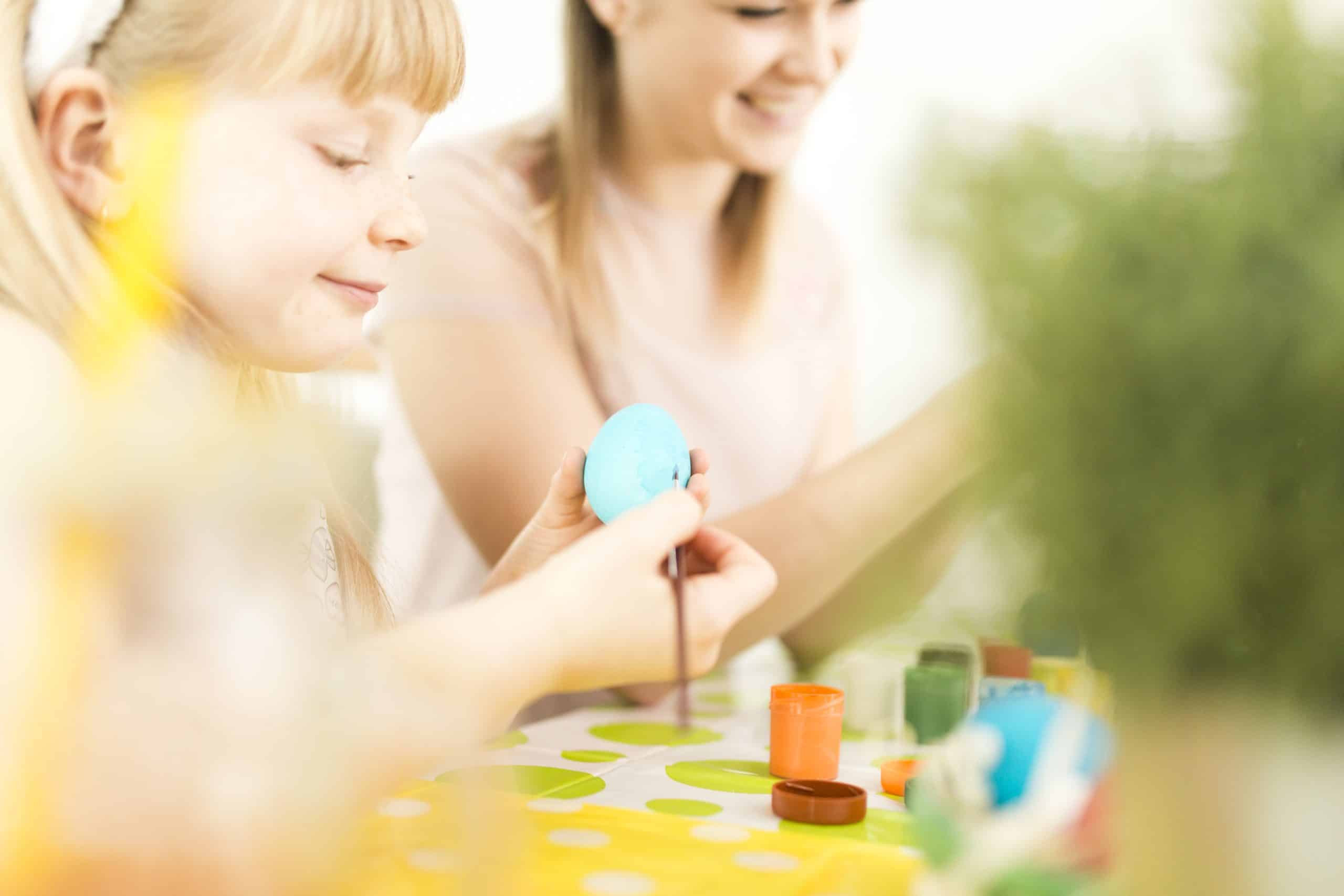 RoomOutlet - mother girl decorating easter eggs scaled
